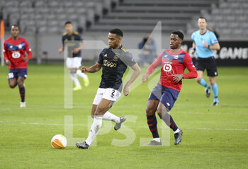 2021-02-18 - Jurrien Timber of Ajax, Jonathan David of Lille during the UEFA Europa League, round of 32, 1st leg football match between Lille OSC (LOSC) and AFC Ajax Amsterdam on February 18, 2021 at Stade Pierre Mauroy in Villeneuve-d'Ascq near Lille, France - Photo Jean Catuffe / DPPI - LILLE OSC (LOSC) AND AFC AJAX AMSTERDAM - UEFA EUROPA LEAGUE - SOCCER