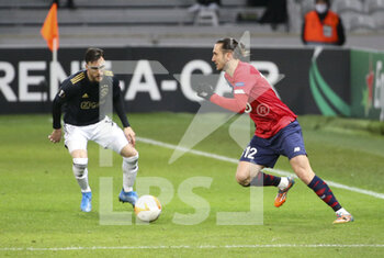 2021-02-18 - Yusuf Yazici of Lille, Nicolas Tagliafico of Ajax (left) during the UEFA Europa League, round of 32, 1st leg football match between Lille OSC (LOSC) and AFC Ajax Amsterdam on February 18, 2021 at Stade Pierre Mauroy in Villeneuve-d'Ascq near Lille, France - Photo Jean Catuffe / DPPI - LILLE OSC (LOSC) AND AFC AJAX AMSTERDAM - UEFA EUROPA LEAGUE - SOCCER