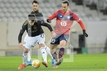 2021-02-18 - Lisandro Martinez of Ajax, Yusuf Yazici of Lille OSC during the UEFA Europa League, round of 32, 1st leg football match between LOSC Lille and AFC Ajax on February 18, 2021 at Pierre Mauroy stadium in Villeneuve-d'Ascq near Lille, France - Photo Gerrit van Keulen / Orange Pictures / DPPI - LOSC LILLE AND AFC AJAX - UEFA EUROPA LEAGUE - SOCCER