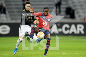 2021-02-18 - Nicolas Tagliafico of Ajax, Timothy Weah of Lille OSC during the UEFA Europa League, round of 32, 1st leg football match between LOSC Lille and AFC Ajax on February 18, 2021 at Pierre Mauroy stadium in Villeneuve-d'Ascq near Lille, France - Photo Gerrit van Keulen / Orange Pictures / DPPI - LOSC LILLE AND AFC AJAX - UEFA EUROPA LEAGUE - SOCCER