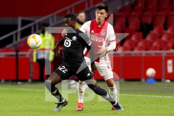 2021-02-25 - Timothy Weah of Lille OSC, Lisandro Martinez of Ajax during the UEFA Europa League, round of 32, 2nd leg football match between Ajax and Lille OSC on February 25, 2021 at Johan Cruijf Arena in Amsterdam, Netherlands - Photo Marcel ter Bals / Orange Pictures / DPPI - AJAX AND LILLE OSC - UEFA EUROPA LEAGUE - SOCCER