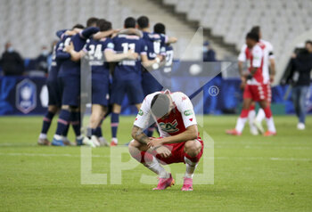 2021-05-19 - Guillermo Maripan of Monaco is dejected while players of PSG celebrate the victory following the French Cup Final football match between AS Monaco (ASM) and Paris Saint-Germain PSG on May 19, 2021 at Stade de France in Saint-Denis near Paris, France - Photo Jean Catuffe / DPPI - FINAL - AS MONACO (ASM) VS PARIS SAINT-GERMAIN PSG - FRENCH CUP - SOCCER