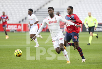 2020-12-06 - Benoit Badiashile of Monaco, Jonathan David of Lille during the French championship Ligue 1 football match between Lille OSC and AS Monaco on December 6, 2020 at Stade Pierre Mauroy in Villeneuve-d'Ascq near Lille, France - Photo Jean Catuffe / DPPI - LILLE OSC VS AS MONACO - FRENCH LIGUE 1 - SOCCER