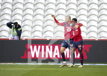 2020-12-06 - Jonathan David of Lille celebrates his goal with Burak Yilmaz of Lille (left) during the French championship Ligue 1 football match between Lille OSC and AS Monaco on December 6, 2020 at Stade Pierre Mauroy in Villeneuve-d'Ascq near Lille, France - Photo Jean Catuffe / DPPI - LILLE OSC VS AS MONACO - FRENCH LIGUE 1 - SOCCER