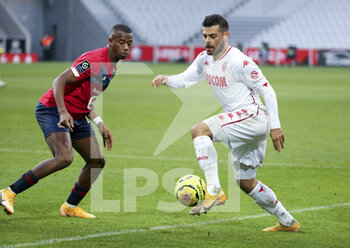 2020-12-06 - Kevin Volland of Monaco, Tiago Djalo of Lille (left) during the French championship Ligue 1 football match between Lille OSC and AS Monaco on December 6, 2020 at Stade Pierre Mauroy in Villeneuve-d'Ascq near Lille, France - Photo Jean Catuffe / DPPI - LILLE OSC VS AS MONACO - FRENCH LIGUE 1 - SOCCER