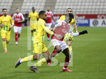 2020-12-16 - El Bilal Toure of Reims, Jean-Charles Castelletto of FC Nantes (left) during the French championship Ligue 1 football match between Stade de Reims and FC Nantes on December 16, 2020 at Stade Auguste Delaune in Reims, France - Photo Jean Catuffe / DPPI - STADE DE REIMS VS FC NANTES - FRENCH LIGUE 1 - SOCCER