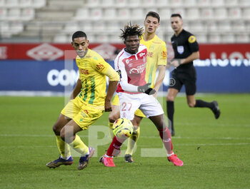 2020-12-16 - Jean-Charles Castelletto of FC Nantes, El Bilal Toure of Reims during the French championship Ligue 1 football match between Stade de Reims and FC Nantes on December 16, 2020 at Stade Auguste Delaune in Reims, France - Photo Jean Catuffe / DPPI - STADE DE REIMS VS FC NANTES - FRENCH LIGUE 1 - SOCCER