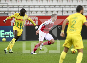 2020-12-16 - Abdoulaye Toure of FC Nantes, Kaj Sierhuis of Reims during the French championship Ligue 1 football match between Stade de Reims and FC Nantes on December 16, 2020 at Stade Auguste Delaune in Reims, France - Photo Jean Catuffe / DPPI - STADE DE REIMS VS FC NANTES - FRENCH LIGUE 1 - SOCCER