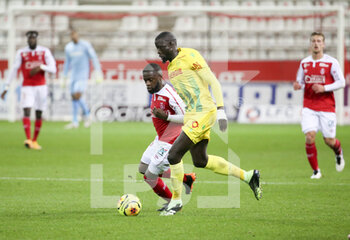 2020-12-16 - Abdoulaye Toure of FC Nantes, Moussa Doumbia of Reims during the French championship Ligue 1 football match between Stade de Reims and FC Nantes on December 16, 2020 at Stade Auguste Delaune in Reims, France - Photo Jean Catuffe / DPPI - STADE DE REIMS VS FC NANTES - FRENCH LIGUE 1 - SOCCER