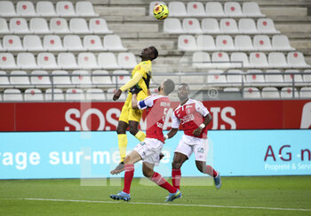 2020-12-16 - Dennis Appiah of FC Nantes, Yunis Abdelhamid and Ghislain Konan of Reims during the French championship Ligue 1 football match between Stade de Reims and FC Nantes on December 16, 2020 at Stade Auguste Delaune in Reims, France - Photo Jean Catuffe / DPPI - STADE DE REIMS VS FC NANTES - FRENCH LIGUE 1 - SOCCER