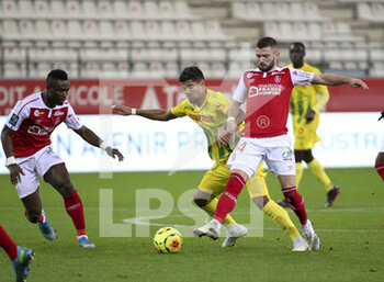 2020-12-16 - Ludovic Blas of FC Nantes between Ghislain Konan and Valon Berisha of Reims during the French championship Ligue 1 football match between Stade de Reims and FC Nantes on December 16, 2020 at Stade Auguste Delaune in Reims, France - Photo Jean Catuffe / DPPI - STADE DE REIMS VS FC NANTES - FRENCH LIGUE 1 - SOCCER