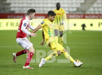 2020-12-16 - Ludovic Blas of FC Nantes, Thomas Foket of Reims (left) during the French championship Ligue 1 football match between Stade de Reims and FC Nantes on December 16, 2020 at Stade Auguste Delaune in Reims, France - Photo Jean Catuffe / DPPI - STADE DE REIMS VS FC NANTES - FRENCH LIGUE 1 - SOCCER
