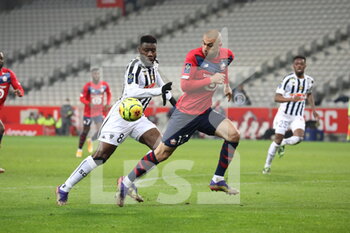 2021-01-06 - Burak Yilmaz 17 LOSC and Ismael TRAORE 8 ANgers during the French championship Ligue 1 football match between Lille OSC and Angers SCO on January 6, 2021 at Pierre Mauroy stadium in Villeneuve-d'Ascq near Lille, France - Photo Laurent Sanson / LS Medianord / DPPI - LILLE OSC VS ANGERS SCO - FRENCH LIGUE 1 - SOCCER