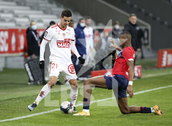 2021-02-14 - Romain Faivre of Brest, Tiago Djalo of Lille during the French championship Ligue 1 football match between Lille OSC (LOSC) and Stade Brestois 29 (Brest) on February 14, 2021 at Stade Pierre Mauroy in Villeneuve-d'Ascq near Lille, France - Photo Jean Catuffe / DPPI - LILLE OSC (LOSC) AND STADE BRESTOIS 29 (BREST) - FRENCH LIGUE 1 - SOCCER
