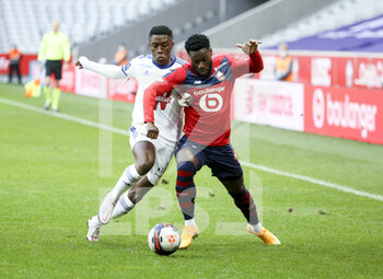 2021-02-28 - Jonathan Bamba of Lille, Jean-Ricner Bellegarde of Strasbourg (left) during the French championship Ligue 1 football match between Lille OSC and RC Strasbourg on february 28, 2021 at Pierre Mauroy stadium in Villeneuve-d'Ascq near Lille, France - Photo Jean Catuffe / DPPI - LILLE OSC AND RC STRASBOURG - FRENCH LIGUE 1 - SOCCER