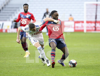 2021-02-28 - Jonathan Ikone of Lille, Stefan Mitrovic of Strasbourg (left) during the French championship Ligue 1 football match between Lille OSC and RC Strasbourg on february 28, 2021 at Pierre Mauroy stadium in Villeneuve-d'Ascq near Lille, France - Photo Jean Catuffe / DPPI - LILLE OSC AND RC STRASBOURG - FRENCH LIGUE 1 - SOCCER