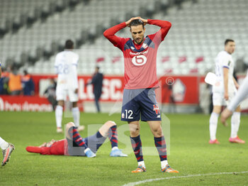 2021-02-28 - Yusuf Yazici of Lille and Xeka of Lille (left, lying down) are dejected following the French championship Ligue 1 football match between Lille OSC and RC Strasbourg on february 28, 2021 at Pierre Mauroy stadium in Villeneuve-d'Ascq near Lille, France - Photo Jean Catuffe / DPPI - LILLE OSC AND RC STRASBOURG - FRENCH LIGUE 1 - SOCCER
