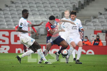 2021-03-03 - Jonathan David 9 losc duel Balerdi 5 Marseille and Gueye 22 Marseille during the French championship Ligue 1 football match between Lille OSC and Olympique de Marseille on March 3, 2021 at Pierre Mauroy stadium in Villeneuve-d'Ascq near Lille, France - Photo Laurent Sanson / LS Medianord / DPPI - LILLE OSC AND OLYMPIQUE DE MARSEILLE - FRENCH LIGUE 1 - SOCCER