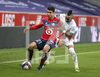 2021-03-03 - Benjamin Andre of Lille, Dimitri Payet of Marseille during the French championship Ligue 1 football match between Lille OSC and Olympique de Marseille on March 3, 2021 at Pierre Mauroy stadium in Villeneuve-d'Ascq near Lille, France - Photo Jean Catuffe / DPPI - LILLE OSC AND OLYMPIQUE DE MARSEILLE - FRENCH LIGUE 1 - SOCCER