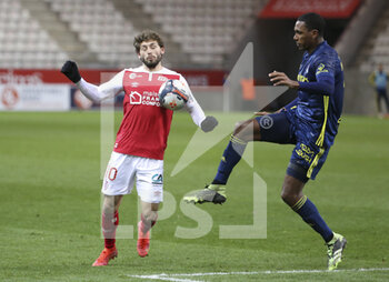 2021-03-12 - Arber Zeneli of Reims, Marcelo Guedes of Lyon during the French championship Ligue 1 football match between Stade de Reims and Olympique Lyonnais (OL) on March 12, 2021 at Stade Auguste Delaune in Reims, France - Photo Jean Catuffe / DPPI - STADE DE REIMS AND OLYMPIQUE LYONNAIS (OL) - FRENCH LIGUE 1 - SOCCER