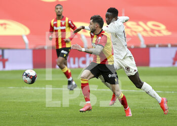 2021-03-14 - Jonathan Clauss of Lens, Pape Matar Sarr of Metz during the French championship Ligue 1 football match between RC Lens and FC Metz on March 14, 2021 at Stade Bollaert-Delelis in Lens, France - Photo Jean Catuffe / DPPI - RC LENS AND FC METZ - FRENCH LIGUE 1 - SOCCER