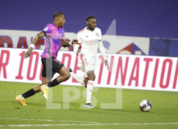2021-03-21 - Karl Toko Ekambi of Lyon, Presnel Kimpembe of PSG (left) during the French championship Ligue 1 football match between Olympique Lyonnais and Paris Saint-Germain on March 21, 2021 at Groupama stadium in Decines-Charpieu near Lyon, France - Photo Jean Catuffe / DPPI - OLYMPIQUE LYONNAIS AND PARIS SAINT-GERMAIN - FRENCH LIGUE 1 - SOCCER