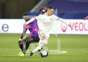 2021-03-21 - Maxence Caqueret of Lyon, Idrissa Gueye Gana of PSG (left) during the French championship Ligue 1 football match between Olympique Lyonnais (OL) and Paris Saint-Germain (PSG) on March 21, 2021 at Groupama stadium in Decines-Charpieu near Lyon, France - Photo Jean Catuffe / DPPI - OLYMPIQUE LYONNAIS AND PARIS SAINT-GERMAIN - FRENCH LIGUE 1 - SOCCER