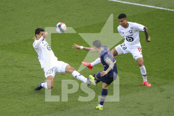 2021-04-03 - Angel Di Maria (PSG) kicked the ball against Benjamin ANDRE (Lille OSC) and Reinildo Mandava (Lille OSC) during the French championship Ligue 1 football match between Paris Saint-Germain and LOSC Lille on April 3, 2021 at Parc des Princes stadium in Paris, France - Photo Stephane Allaman / DPPI - PARIS SAINT-GERMAIN AND LOSC LILLE - FRENCH LIGUE 1 - SOCCER