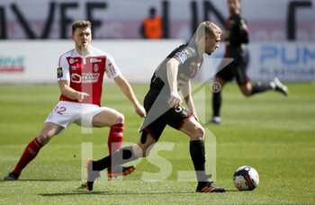 2021-04-04 - Adrien Truffert of Rennes, Thomas Foket of Reims (left) during the French championship Ligue 1 football match between Stade de Reims and Stade Rennais (Rennes) on April 4, 2021 at Stade Auguste Delaune in Reims, France - Photo Jean Catuffe / DPPI - STADE DE REIMS VS STADE RENNAIS (RENNES) - FRENCH LIGUE 1 - SOCCER