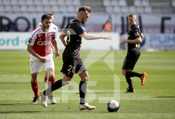 2021-04-04 - Flavien Tait of Rennes, Xavier Chavalerin of Reims (left) during the French championship Ligue 1 football match between Stade de Reims and Stade Rennais (Rennes) on April 4, 2021 at Stade Auguste Delaune in Reims, France - Photo Jean Catuffe / DPPI - STADE DE REIMS VS STADE RENNAIS (RENNES) - FRENCH LIGUE 1 - SOCCER