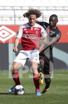 2021-04-04 - Wout Faes of Reims, Serhou Guirassy of Rennes during the French championship Ligue 1 football match between Stade de Reims and Stade Rennais (Rennes) on April 4, 2021 at Stade Auguste Delaune in Reims, France - Photo Jean Catuffe / DPPI - STADE DE REIMS VS STADE RENNAIS (RENNES) - FRENCH LIGUE 1 - SOCCER