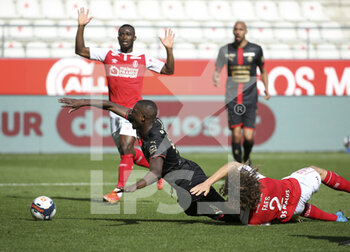 2021-04-04 - Serhou Guirassy of Rennes, Wout Faes of Reims during the French championship Ligue 1 football match between Stade de Reims and Stade Rennais (Rennes) on April 4, 2021 at Stade Auguste Delaune in Reims, France - Photo Jean Catuffe / DPPI - STADE DE REIMS VS STADE RENNAIS (RENNES) - FRENCH LIGUE 1 - SOCCER