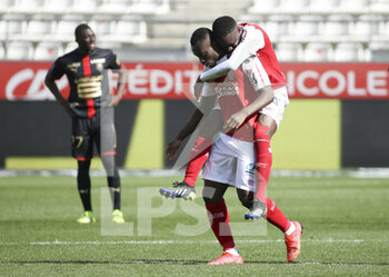 2021-04-04 - Ghislain Konan of Reims celebrates his goal with Moreto Cassama during the French championship Ligue 1 football match between Stade de Reims and Stade Rennais (Rennes) on April 4, 2021 at Stade Auguste Delaune in Reims, France - Photo Jean Catuffe / DPPI - STADE DE REIMS VS STADE RENNAIS (RENNES) - FRENCH LIGUE 1 - SOCCER