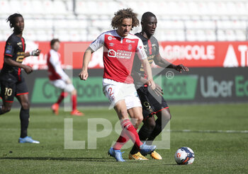 2021-04-04 - Wout Faes of Reims, Serhou Guirassy of Rennes during the French championship Ligue 1 football match between Stade de Reims and Stade Rennais (Rennes) on April 4, 2021 at Stade Auguste Delaune in Reims, France - Photo Jean Catuffe / DPPI - STADE DE REIMS VS STADE RENNAIS (RENNES) - FRENCH LIGUE 1 - SOCCER