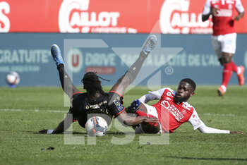 2021-04-04 - Moreto Cassama of Reims commits a foul on Eduardo Camavinga of Rennes (left) and receives a red card during the French championship Ligue 1 football match between Stade de Reims and Stade Rennais (Rennes) on April 4, 2021 at Stade Auguste Delaune in Reims, France - Photo Jean Catuffe / DPPI - STADE DE REIMS VS STADE RENNAIS (RENNES) - FRENCH LIGUE 1 - SOCCER