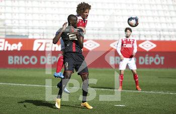 2021-04-04 - Serhou Guirassy of Rennes, Wout Faes of Reims during the French championship Ligue 1 football match between Stade de Reims and Stade Rennais (Rennes) on April 4, 2021 at Stade Auguste Delaune in Reims, France - Photo Jean Catuffe / DPPI - STADE DE REIMS VS STADE RENNAIS (RENNES) - FRENCH LIGUE 1 - SOCCER