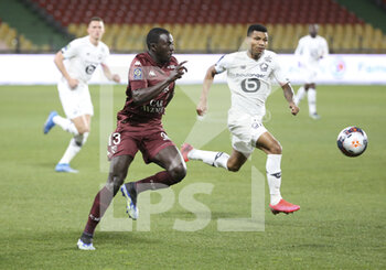 2021-04-09 - Lamine Gueye of FC Metz, Reinildo Mandava of Lille during the French championship Ligue 1 football match between FC Metz and Lille OSC (LOSC) on April 9, 2021 at Stade Saint-Symphorien in Metz, France - Photo Jean Catuffe / DPPI - FC METZ VS LILLE OSC (LOSC) - FRENCH LIGUE 1 - SOCCER