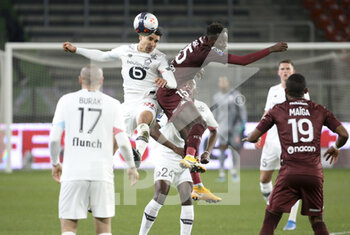 2021-04-09 - Benjamin Andre of Lille, Pape Matar Sarr of FC Metz during the French championship Ligue 1 football match between FC Metz and Lille OSC (LOSC) on April 9, 2021 at Stade Saint-Symphorien in Metz, France - Photo Jean Catuffe / DPPI - FC METZ VS LILLE OSC (LOSC) - FRENCH LIGUE 1 - SOCCER