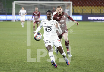 2021-04-09 - Timothy Weah of Lille, Thomas Delaine of FC Metz during the French championship Ligue 1 football match between FC Metz and Lille OSC (LOSC) on April 9, 2021 at Stade Saint-Symphorien in Metz, France - Photo Jean Catuffe / DPPI - FC METZ VS LILLE OSC (LOSC) - FRENCH LIGUE 1 - SOCCER