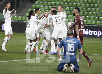 2021-04-09 - Jose Fonte, Renato Sanches, Reinildo Mandava, Sven Botman of Lille and teammates celebrate a goal for Lille while goalkeeper of FC Metz Alexandre Oukidja, Dylan Bronn of FC Metz are dejected during the French championship Ligue 1 football match between FC Metz and Lille OSC (LOSC) on April 9, 2021 at Stade Saint-Symphorien in Metz, France - Photo Jean Catuffe / DPPI - FC METZ VS LILLE OSC (LOSC) - FRENCH LIGUE 1 - SOCCER