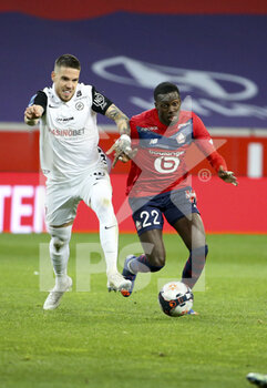 2021-04-16 - Mihailo Ristic of Montpellier, Timothy Weah of Lille during the French championship Ligue 1 football match between LOSC and Montpellier HSC on April 16, 2021 at Pierre Mauroy stadium in Villeneuve-d'Ascq near Lille, France - Photo Jean Catuffe / DPPI - LOSC VS MONTPELLIER HSC - FRENCH LIGUE 1 - SOCCER