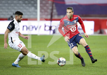 2021-04-16 - Yusuf Yazici of Lille, Jordan Ferri of Montpellier (left) during the French championship Ligue 1 football match between LOSC and Montpellier HSC on April 16, 2021 at Pierre Mauroy stadium in Villeneuve-d'Ascq near Lille, France - Photo Jean Catuffe / DPPI - LOSC VS MONTPELLIER HSC - FRENCH LIGUE 1 - SOCCER