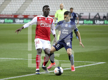 2021-04-23 - Dion Lopy of Reims, Yuto Nagatomo of Marseille during the French championship Ligue 1 football match between Stade de Reims and Olympique de Marseille (OM) on April 23, 2021 at Stade Auguste Delaune in Reims, France - Photo Jean Catuffe / DPPI - STADE DE REIMS VS OLYMPIQUE DE MARSEILLE (OM) - FRENCH LIGUE 1 - SOCCER
