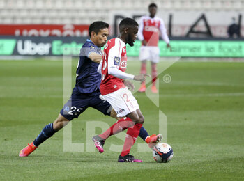 2021-04-23 - Moreto Cassama of Reims, Yuto Nagatomo of Marseille (left) during the French championship Ligue 1 football match between Stade de Reims and Olympique de Marseille (OM) on April 23, 2021 at Stade Auguste Delaune in Reims, France - Photo Jean Catuffe / DPPI - STADE DE REIMS VS OLYMPIQUE DE MARSEILLE (OM) - FRENCH LIGUE 1 - SOCCER