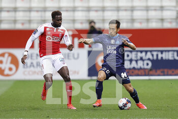 2021-04-23 - Yuto Nagatomo of OM and Boulaye Dia of Reims during the French championship Ligue 1 football match between Stade de Reims and Olympique de Marseille on April 23, 2021 at Auguste Delaune stadium in Reims, France - Photo Loic Baratoux / DPPI - STADE DE REIMS VS OLYMPIQUE DE MARSEILLE (OM) - FRENCH LIGUE 1 - SOCCER