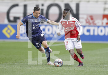 2021-04-23 - Florian Thauvin of OM and Moreto Cassama of Reims during the French championship Ligue 1 football match between Stade de Reims and Olympique de Marseille on April 23, 2021 at Auguste Delaune stadium in Reims, France - Photo Loic Baratoux / DPPI - STADE DE REIMS VS OLYMPIQUE DE MARSEILLE (OM) - FRENCH LIGUE 1 - SOCCER