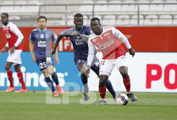 2021-04-23 - Dion Lopy of Reims and Pape Gueye of OM during the French championship Ligue 1 football match between Stade de Reims and Olympique de Marseille on April 23, 2021 at Auguste Delaune stadium in Reims, France - Photo Loic Baratoux / DPPI - STADE DE REIMS VS OLYMPIQUE DE MARSEILLE (OM) - FRENCH LIGUE 1 - SOCCER