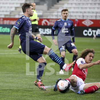 2021-04-23 - Pol Lirola of Marseille, Wout Faes of Reims during the French championship Ligue 1 football match between Stade de Reims and Olympique de Marseille (OM) on April 23, 2021 at Stade Auguste Delaune in Reims, France - Photo Jean Catuffe / DPPI - STADE DE REIMS VS OLYMPIQUE DE MARSEILLE (OM) - FRENCH LIGUE 1 - SOCCER