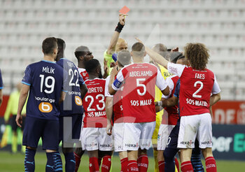 2021-04-23 - Wout Faes of Reims receives a red card during the French championship Ligue 1 football match between Stade de Reims and Olympique de Marseille on April 23, 2021 at Auguste Delaune stadium in Reims, France - Photo Loic Baratoux / DPPI - STADE DE REIMS VS OLYMPIQUE DE MARSEILLE (OM) - FRENCH LIGUE 1 - SOCCER