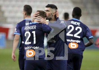 2021-04-23 - Alvaro Gonzalez of Marseille celebrates the third goal of his team with Valentin Rongier (left) during the French championship Ligue 1 football match between Stade de Reims and Olympique de Marseille (OM) on April 23, 2021 at Stade Auguste Delaune in Reims, France - Photo Jean Catuffe / DPPI - STADE DE REIMS VS OLYMPIQUE DE MARSEILLE (OM) - FRENCH LIGUE 1 - SOCCER